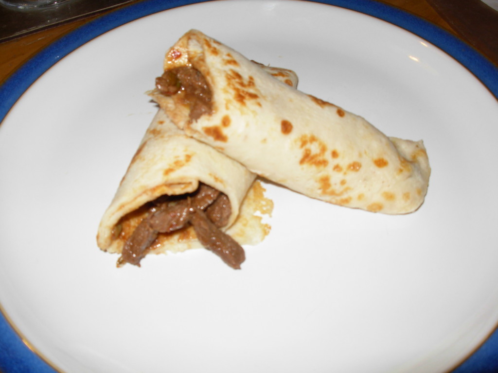rolled pancakes cut in half to show chilli beef filling inside