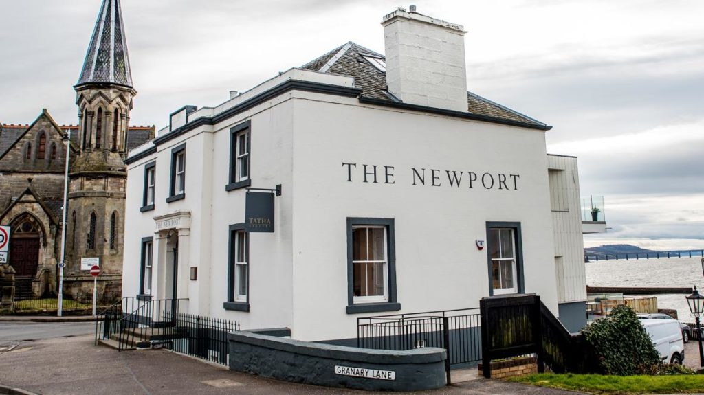 The Newport Restaurant - a large free standing white building with the name written on the side wall